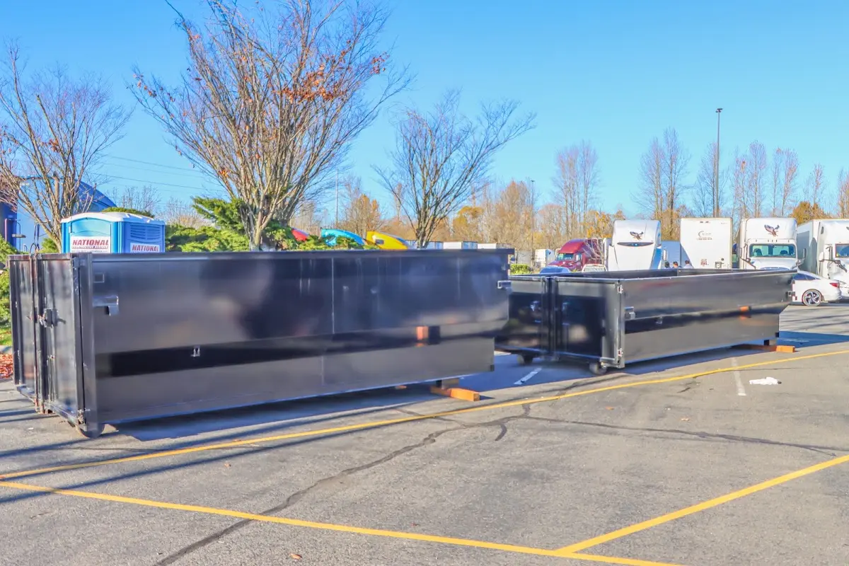 Professional dumpster rental service with roll-off container on residential driveway in Lamont